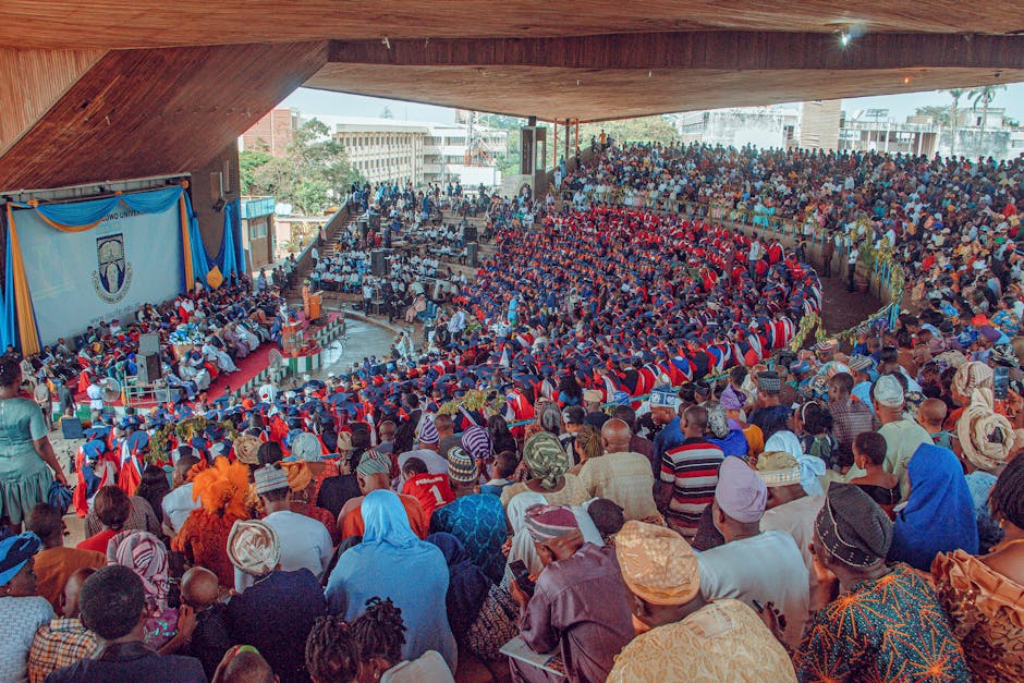 Large audience at a graduation ceremony in Ife, Nigeria, showcasing cultural diversity and academic celebration. Large audience at a graduation ceremony in Ife, Nigeria, showcasing cultural diversity and academic celebration.