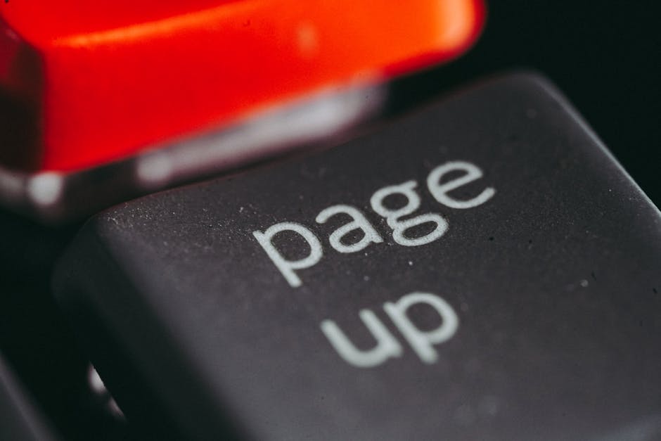 Close-up macro photography of a keyboard’s ‘page up’ key, highlighting its texture and design. Close-up macro photography of a keyboard's 'page up' key, highlighting its texture and design.