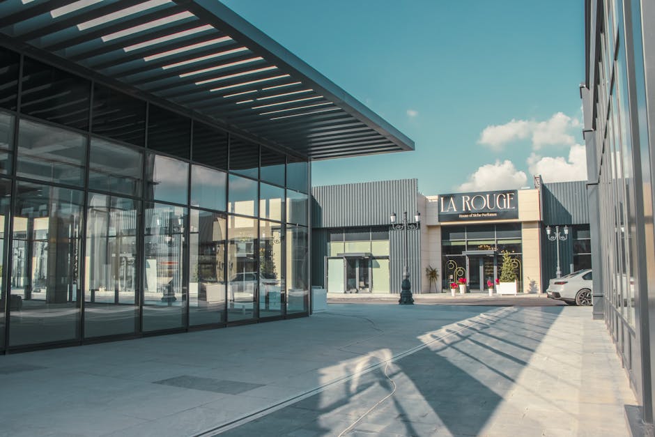 Elegant shopping arcade featuring modern architecture and glass facades under a clear sky. Elegant shopping arcade featuring modern architecture and glass facades under a clear sky.