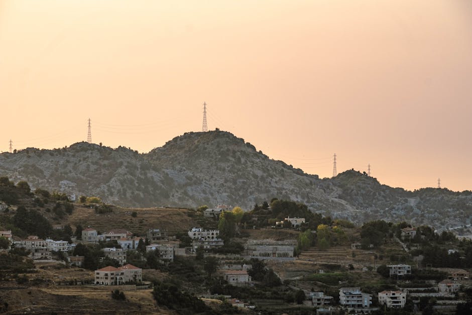 A picturesque village nestled in the mountains with sunset hues casting a warm glow. A picturesque village nestled in the mountains with sunset hues casting a warm glow.