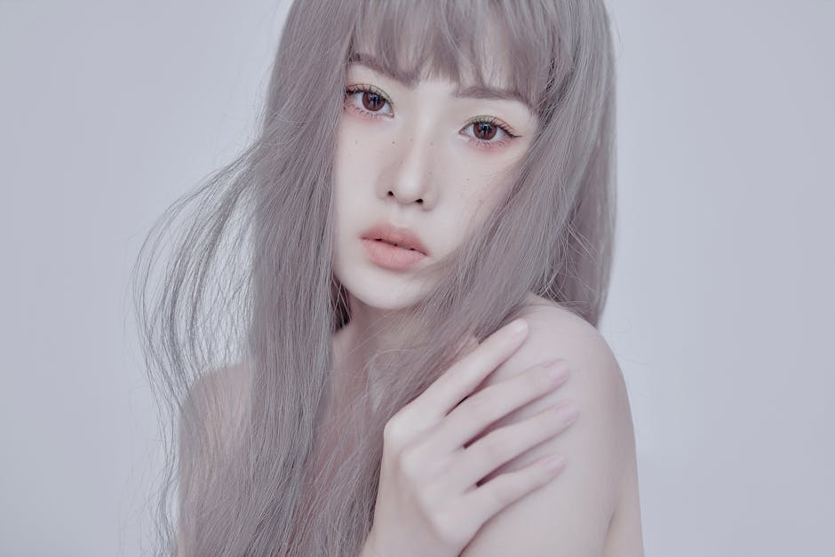 Close-up portrait of an elegant woman with gray hair and soft expression.