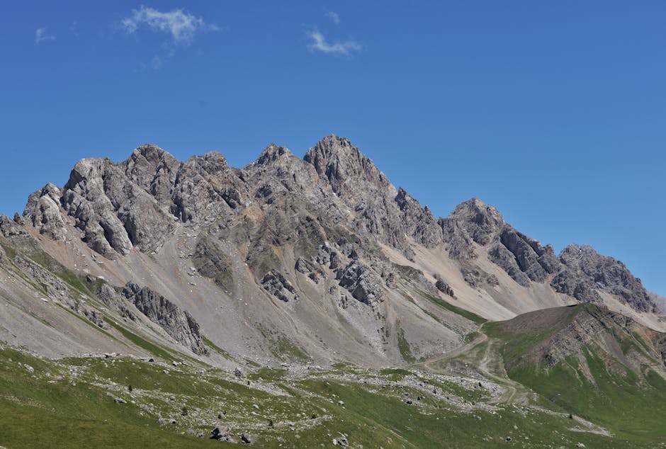 Breathtaking view of the rugged San Pellegrino peaks in Trentino-Alto Adige, Italy, under a clear blue sky.