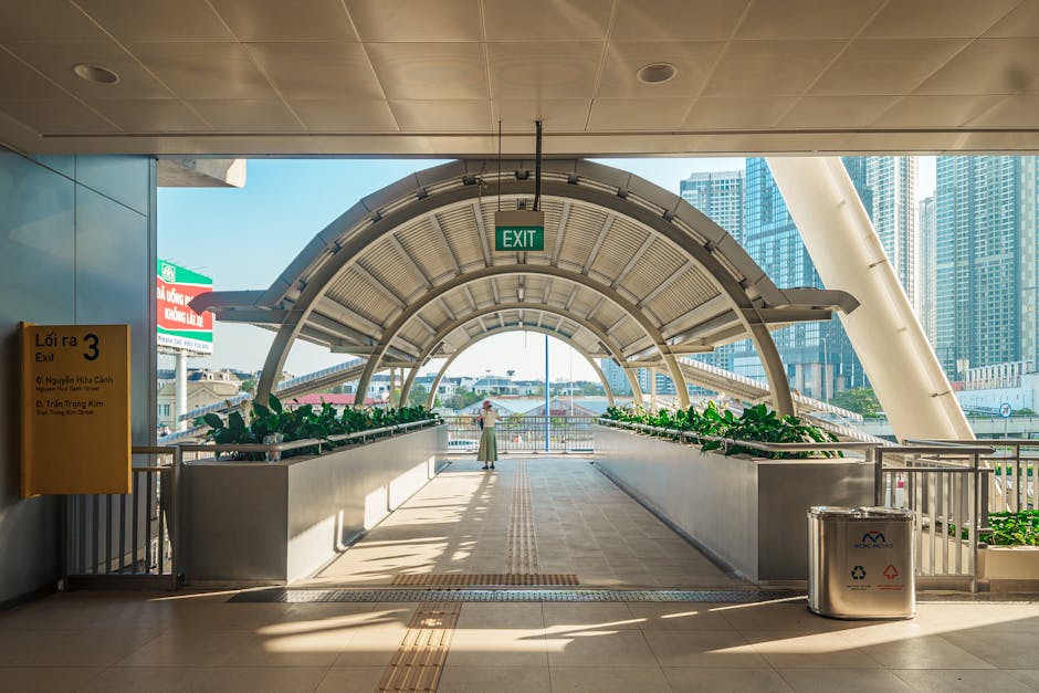 Modern walkway with cityscape in Ho Chi Minh City, featuring architectural details and green plants. Modern walkway with cityscape in Ho Chi Minh City, featuring architectural details and green plants.